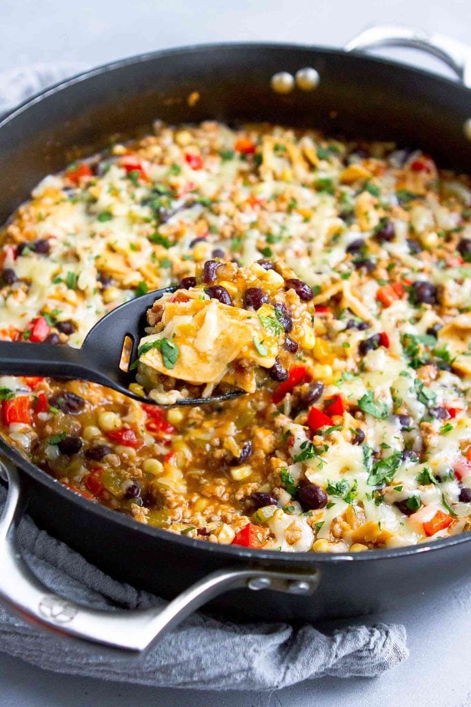 Ground turkey skillet meal topped with cheese in a large skillet.