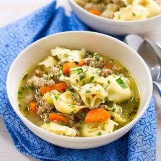 My family LOVES this Pesto Turkey Tortellini Soup recipe! And really, you can never have enough 30 minute recipes in your arsenal. 230 calories and 4 Weight Watchers SP | Ground Turkey | Stovetop | Easy | Healthy | 30 Minute Meal | Recipes | Broth #tortellinisoup #30minutemeals #easydinnerrecipes #souprecipes #healthysoups #weightwatchers #smartpoints