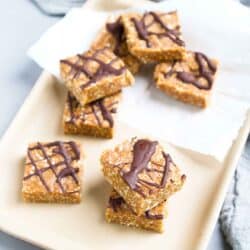 Sweetened with dates and chock full of whole grains, these Chocolate Peanut Butter Oatmeal Bars will curb your sweet tooth in just a few bites. 161 calories and 7 Weight Watchers SP | No Bake | Healthy | Plant Based | Date | Vegan | Recipes | Kamut | Chewy #oatmealbars #datebars #medjooldates #vegansnacks #plantbased