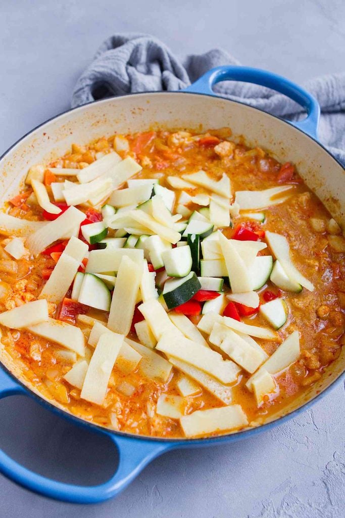 Cauliflower, bamboo shoots and zucchini in a large skillet with curry mixture