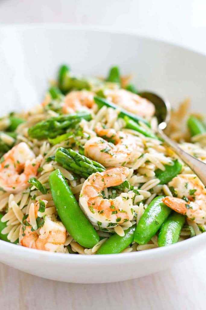 Welcome spring with this Shrimp Pasta Primavera Salad! Packed with asparagus and snap peas, it’s perfect for a light dinner or picnic lunch. 219 calories and 4 Weight Watchers SP | With Lemon Dressing | Easy | Healthy | Recipes | Summer | Cold | Best | Orzo #pastasalad #picnicrecipes #potluckrecipes #shrimprecipes #weightwatchers #smartpoints