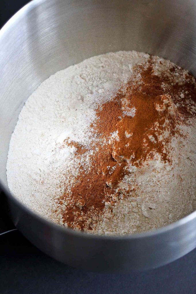Whole wheat pastry flour and ground cinnamon in a large stainless steel bowl