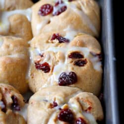 These whole wheat hot cross buns are perfect for Easter brunch. Tart cherries and lemon glaze add a sweet tang to the tender buns. | No Raisins | Best | Good Friday | Recipe | Best | Traditional #hotcrossbuns #easterbrunch #brunchrecipes #makeahead #sweetbuns #holidayrecipes #easterrecipes