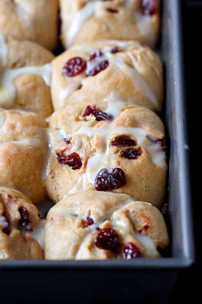 These whole wheat hot cross buns are perfect for Easter brunch. Tart cherries and lemon glaze add a sweet tang to the tender buns. | No Raisins | Best | Good Friday | Recipe | Best | Traditional #hotcrossbuns #easterbrunch #brunchrecipes #makeahead #sweetbuns #holidayrecipes #easterrecipes