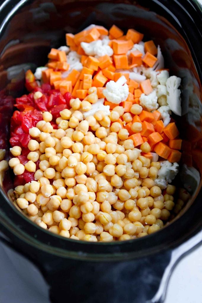 Garbanzo beans (chickpeas), canned tomatoes, sweet potatoes and cauliflower in a crockpot