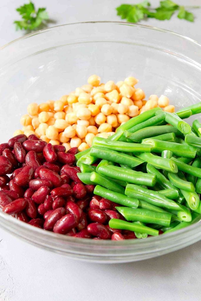 Green beans, chickpeas and kidney beans in a glass bowl.