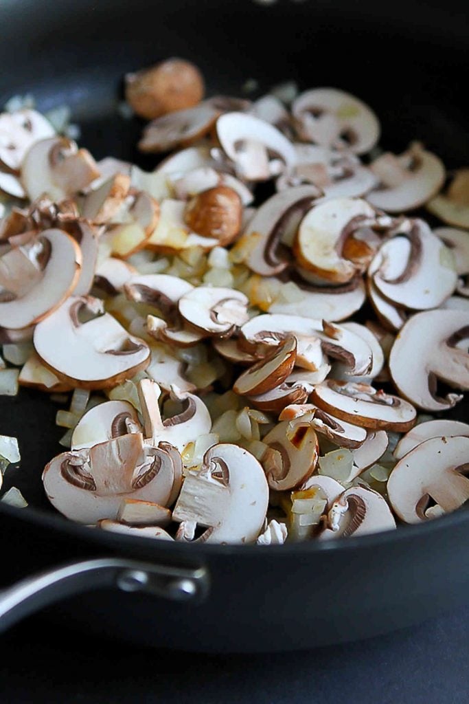Sliced mushrooms and chopped onions in a large nonstick skillet.