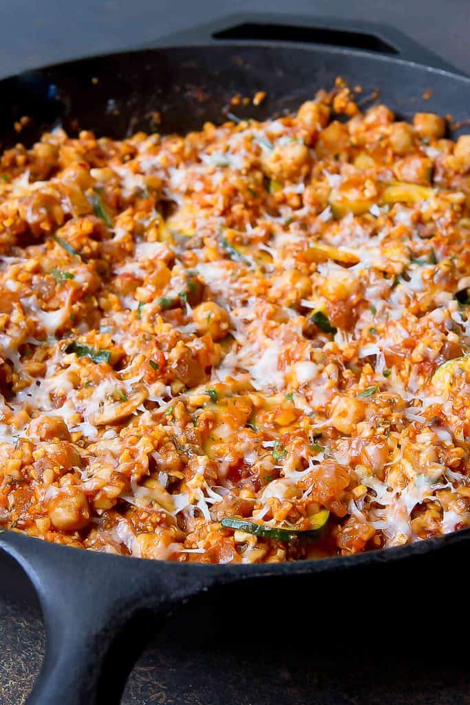 There is so much goodness in this easy Vegetarian Cauliflower Rice Skillet Meal! One-pot dinners are lifesavers on busy weeknights and this one is no exception. 246 calories and 5 Weight Watchers SP | No Meat | Meatless | Chickpea | Garbanzo beans | Mushroom | One Pot | Zucchini #healthydinners #cauliflowerrice #onepotmeal #onepotdinne