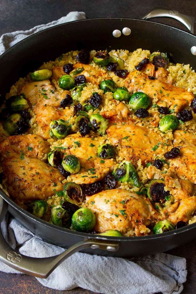 Chicken and Brussels sprouts with quinoa and dried cherries in a nonstick skillet.