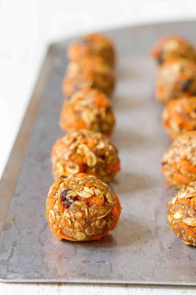 Close-up of healthy carrot cake granola snacks on a silver baking sheet.