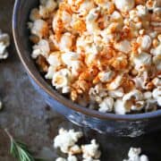 Popcorn topped with paprika olive oil, in a large blue bowl.