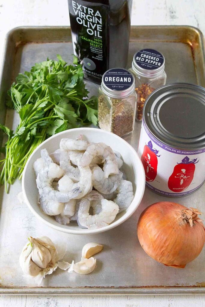 Ingredients for shrimp in tomato sauce recipe, all on baking sheet.