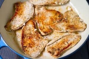 Browned pieces of turkey breast in a large skillet.
