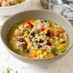 Ground turkey soup with black beans in a gray bowl.