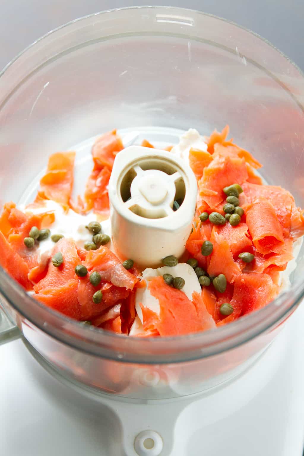 Cream cheese, smoked salmon pieces and capers in a food processor.