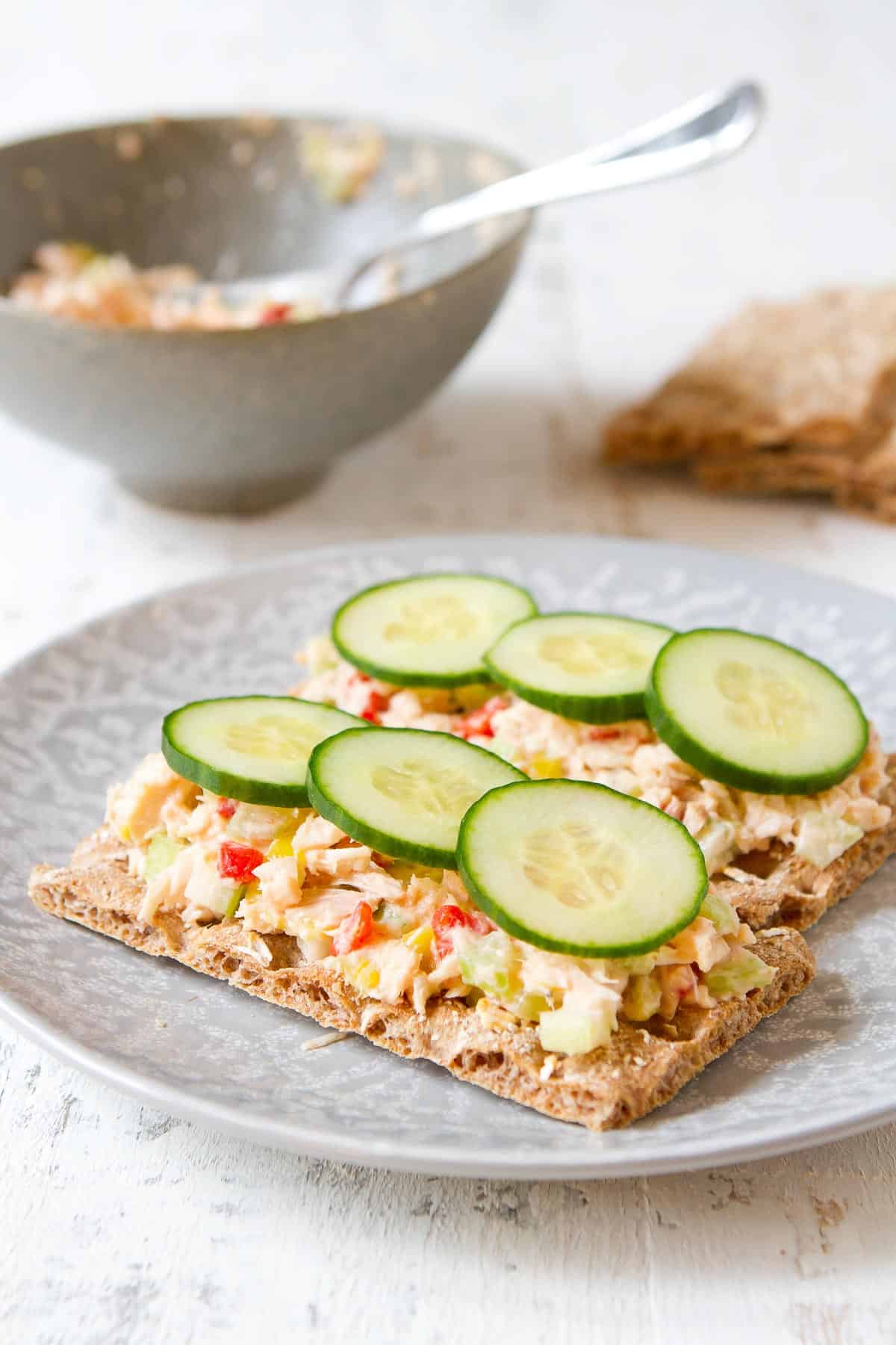Tuna salad on crackers, topped with cucumber slices.