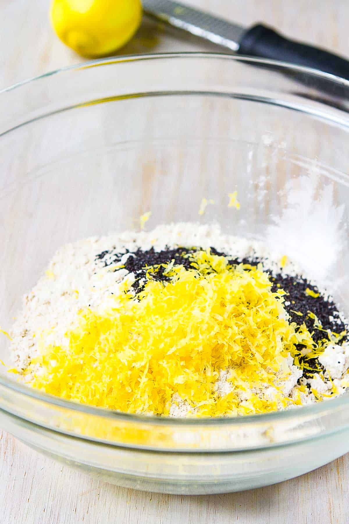 Oat flour, poppy seeds and lemon zest in a bowl.