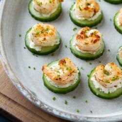 White tray filled with shrimp cucumber cream cheese bites.