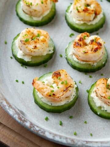 White tray filled with shrimp cucumber cream cheese bites.