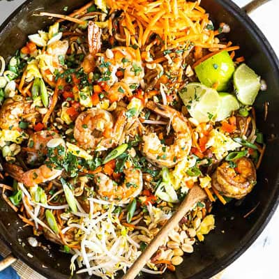 Cooked shrimp, vegetables and peanuts in a bowl.