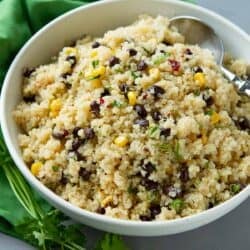 Quinoa salad with black beans and corn in a white bowl.