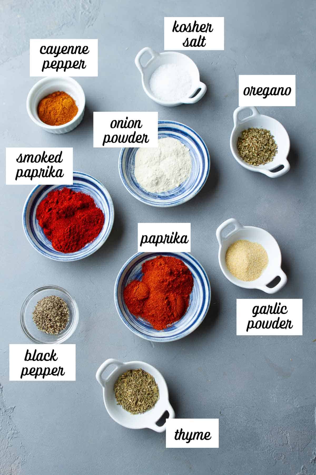 Labeled ingredients for blackening seasoning in various small bowls.
