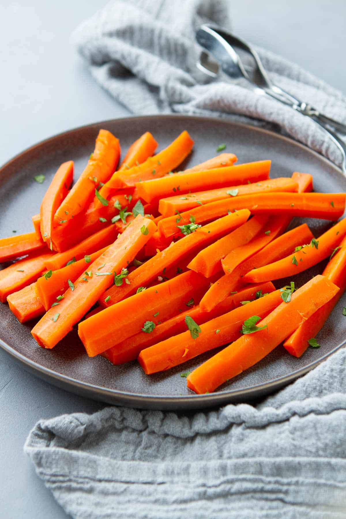Learn how to steam carrots for an easy, healthy side dish. Enjoy tender (not mushy!) steamed carrots that retain their nutrients and bright color.  | In Microwave | On the stove | Stovetop
