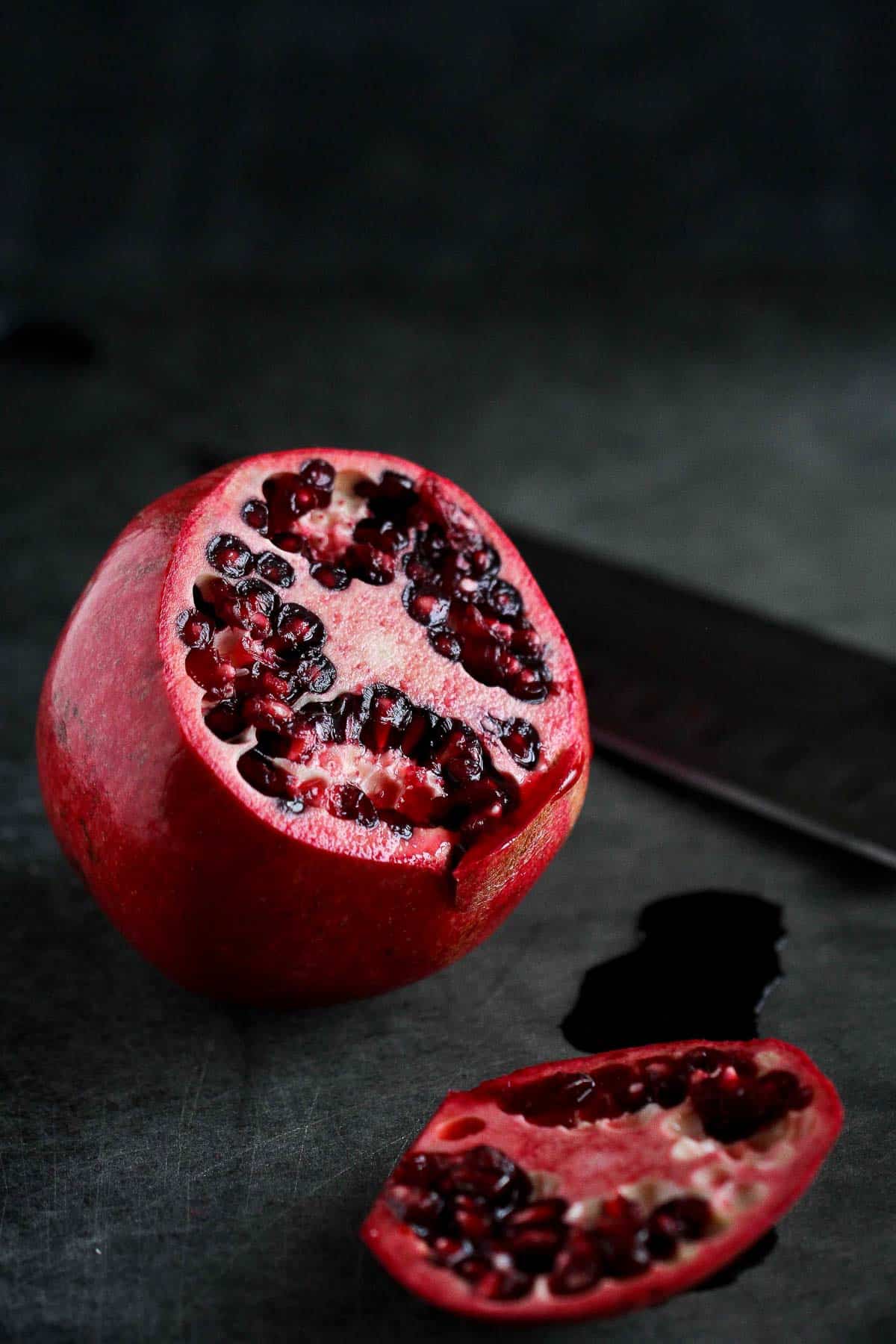 Ever wonder how to seed a pomegranate without making a huge mess? This step-by-step photo tutorial will show you just how easy it is. | Cut pomegranate