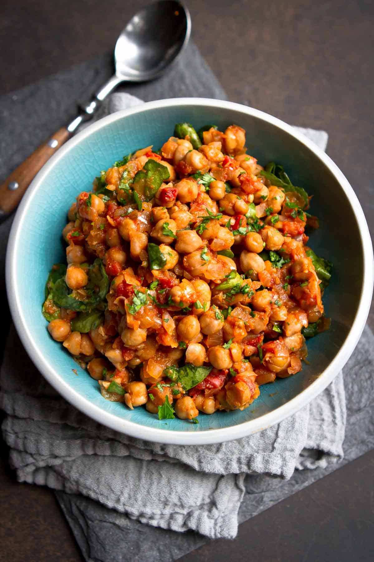 This Crockpot Spiced Chickpea Stew (Vegan) is one of the first meatless meals I fell in love with. So much flavor and your kitchen will smell amazing!  | Vegetarian | Slow Cooker | Mediterranean | Easy | Dinner | Healthy | Spinach | Chana masala