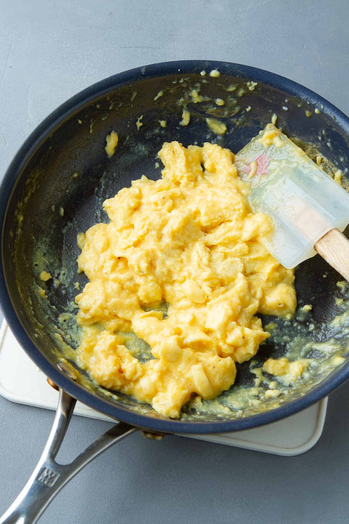 Cooked scrambled egg in a skillet.
