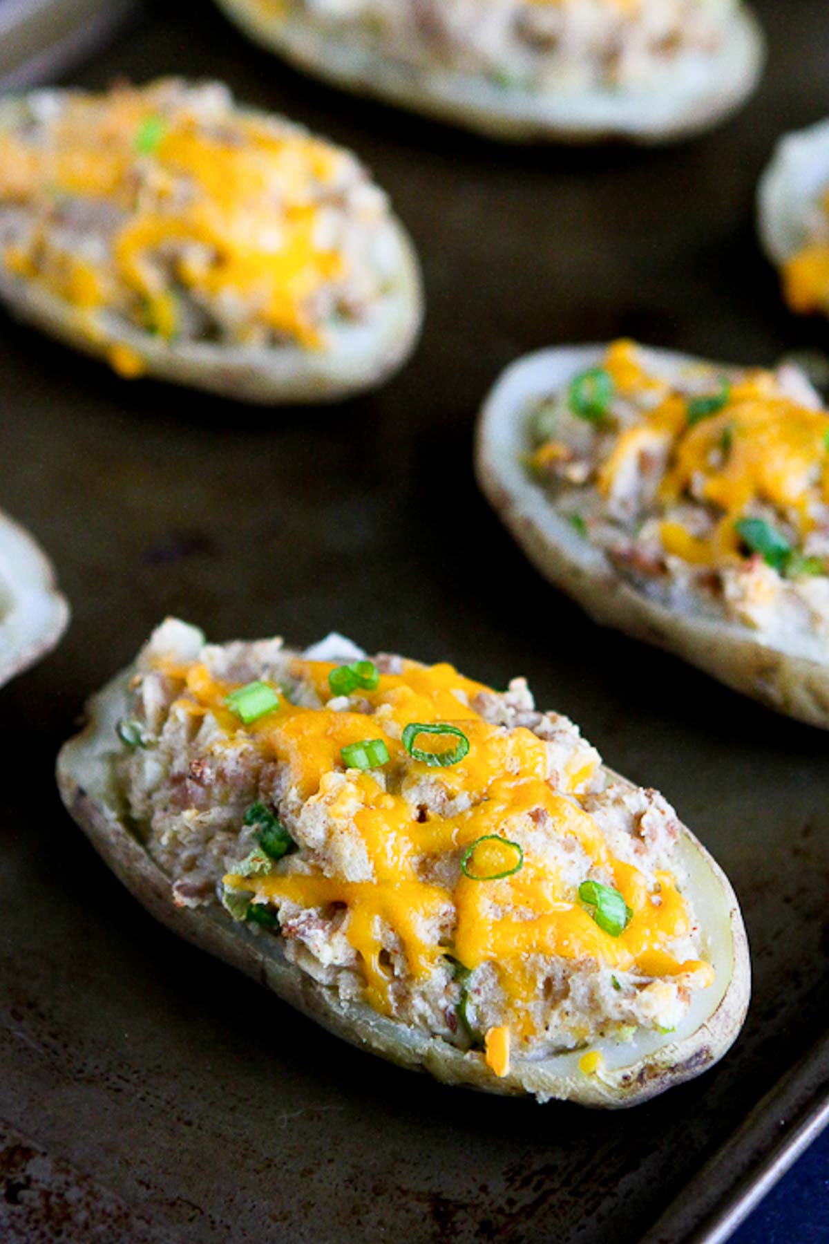 These easy twice-baked ground turkey potatoes are stuffed with creamy mashed potatoes and taco-spiced turkey. They are all topped off with melted cheese. | Recipes ground turkey | Recipes potatoes