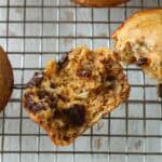 A halved chocolate banana muffin on a cooling rack.