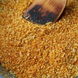 A skillet filled with toasted breadcrumbs.