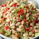 Tuna white bean salad with tomatoes in a white bowl.