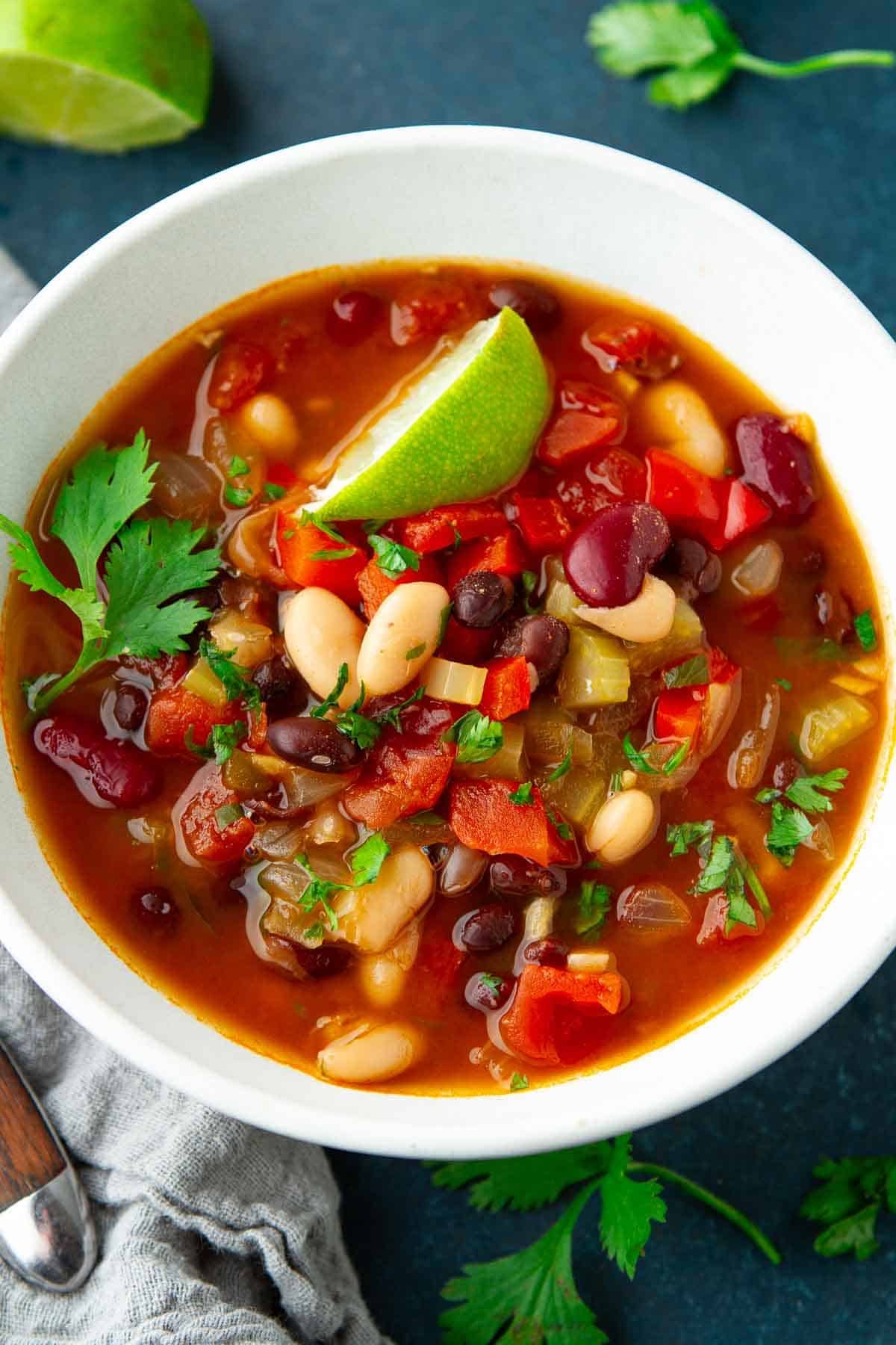 Three bean soup in a white bowl.